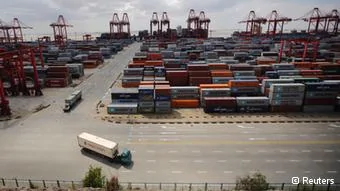  Container trucks drive past the container area at the Yangshan Deep Water Port, part of the newly announced Shanghai Free Trade Zone, south of Shanghai September26,2013. China has formally announced detailed plans for a new free-trade zone(FTZ) in Shanghai, touted as the country's biggest potential economic reform since Deng Xiaoping used a similar zone in Shenzhen to pry open a closed economy to trade in1978. In an announcement on Friday from the State Council, or cabinet, China said it will open up its largely sheltered services sector to foreign competition in the zone and use it as a testbed for bold financial reforms, including a convertible yuan and liberalized interest rates. Economists consider both areas key levers for restructuring the world's second-largest economy and putting it on a more sustainable growth path. Picture taken on September26,2013. REUTERS/Carlos Barria(CHINA- Tags: POLITICS BUSINESS INDUSTRIAL TPX IMAGES OF THE DAY)