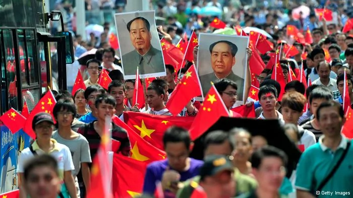 Chinese demonstrators carry national flags and portraits of Mao Zedong during a protest over the Diaoyu islands issue, known as the Senkaku islands in Japan, in Wuhan on September16,2012. Thousands of anti-Japanese demonstrators mounted protests in cities across China on September16 over disputed islands in the East China Sea, a day after an attempt to storm Tokyo's embassy in the capital. CHINA OUT AFP PHOTO(Photo credit should read AFP/AFP/GettyImages)