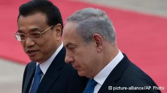 Chinese Premier Li Keqiang, left, chats with Israeli Prime Minister Benjamin Netanyahu during a welcome ceremony outside the Great Hall of the People in Beijing Wednesday, May8,2013.(AP Photo/Alexander F. Yuan)