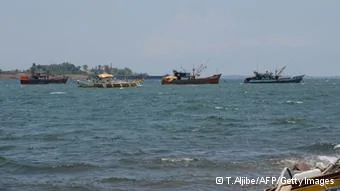 TO GO WITH AFP STORY'PHILIPPINES-CHINA-US-MARITIME-MILITARY-DIPLOMACY-FISHING-FOCUS' by Mynardo Macaraig Fishing boats(2nd L, and at left) also locally known as'mother boats' which are used to transport fish caught around Scarborough shoal, are anchored off Santa Cruz bay, Zambales province, north of Manila, facing south China sea(back) on May10,2012, after arriving a day before from the shoal. For years Filipino and Chinese fishermen peacefully shared the rich harvests around a tiny South China Sea shoal, but today threats, harassment and fear have replaced ocean comradery. AFP PHOTO/TED ALJIBE(Photo credit should read TED ALJIBE/AFP/GettyImages)