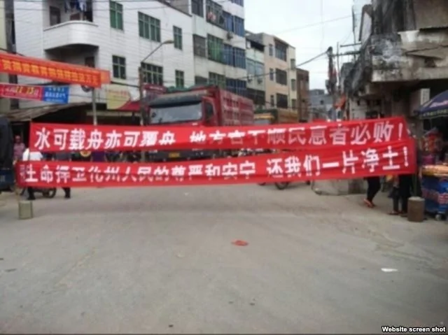 广东省化州市丽岗镇村民游行，打出横幅标语（网络图片）