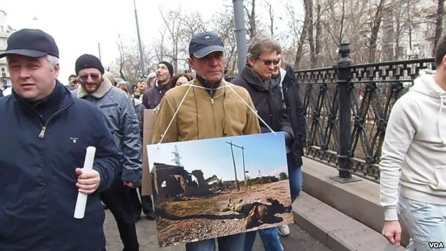今年3月莫斯科反对俄罗斯吞并克里米亚的大规模群众游行中，示威者手举车臣战争照片，警告俄罗斯在走车臣战争之路。(美国之音白桦拍摄)