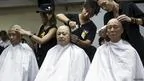 「佔領中環」運動發起人陳健民（左）、戴耀廷（中）和朱耀明（右）在記者面前讓髮型師削髮（9/9/2014）