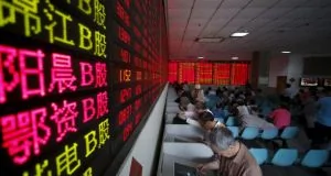 Investors look at computer screens showing stock information at a brokerage house in Shanghai. Photograph: REUTERS/Aly Song