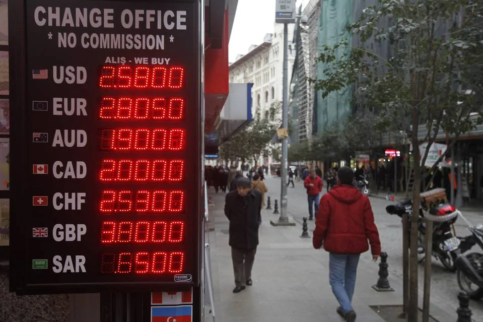 A board displays currency-exchange rates in March in Istanbul, where the Turkish lira recently hit a record low against the dollar.