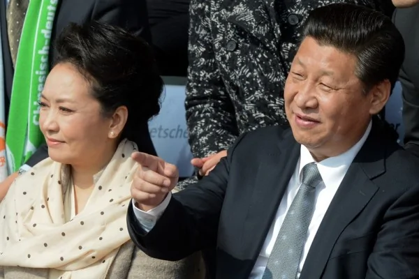 Chinese President Xi Jinping(R) and Chinese First Lady Peng Liyuan attend a friendly football match between VfL Wolfsburg junior team and Chinese youth team from the Rainbow Bridge project on March29,2014 at Olympia stadium in Berlin. AFP PHOTO/ DPA/ SOEREN STACHE/GERMANY OUT(Photo credit should read SOEREN STACHE/AFP/Getty Images)