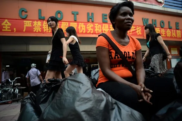 2013年8月26日，來自贊比亞的一名商人坐在廣州一個服裝批發市場之外。(STR/AFP/Getty Images)
