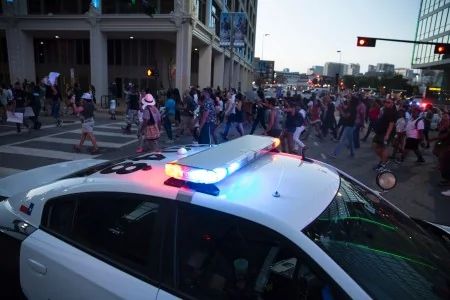 People rally in Dallas, Texas, on Thursday, July7,2016 to protest the deaths of Alton Sterling and Philando Castile. Black motorist Philando Castile,32, a school cafeteria worker, was shot at close range by a Minnesota cop and seen bleeding to death in a graphic video shot by his girlfriend that went viral Thursday, the second fatal police shooting to rock America in as many days./ AFP/ Laura Buckman(Photo credit should read LAURA BUCKMAN/AFP/Getty Images)