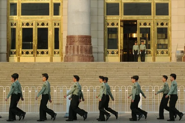 Chinese military policemen march past the Great Hall of the People beside Tiananmen Square in Beijing on May16,2012. A group of Communist Party elders has issued a daring open letter calling for the removal of China's top security official, amid political upheaval ahead of a once-a-decade leadership transition.The calls for the sacking of Zhou Yongkang, one of China's top nine leaders, are closely linked to the recent fall of Bo Xilai-- another high-ranking official-- which triggered the nation's biggest political scandal in decades. AFP PHOTO/Mark RALSTON
