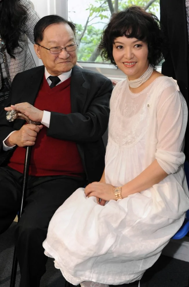 金庸(左)2011年在香港视觉艺术中心参加女儿查传讷个人画展。(新华社资料照片)
