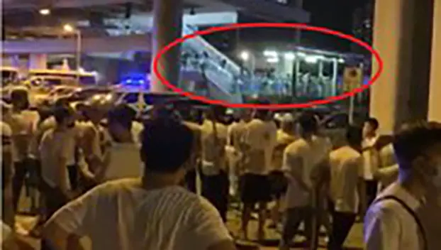 2019年7月21日，鎮暴警察（紅圈所示）到場時，大批「白衣人」仍在香港元朗西鐵站外聚集，並持有木棍等攻擊性武器，但警方未採取拘捕行動。（視頻截圖） 