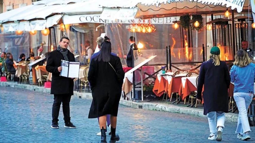 图为罗马纳沃纳广场一名侍应游说顾客进入餐厅用餐。