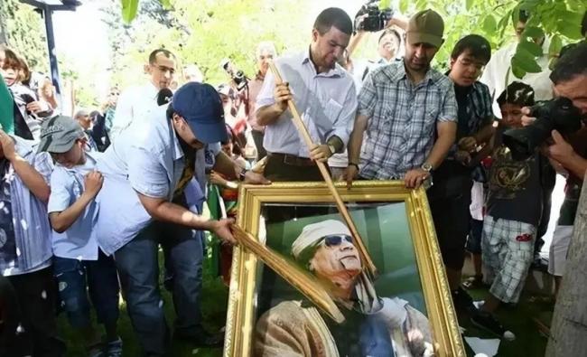卡扎菲臨死前慘狀：被拖行40多米，手抹眼淚求饒，士兵拿手機拍照